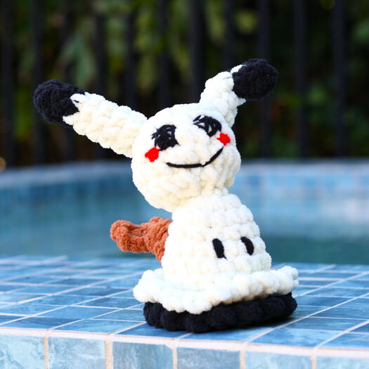 A pokemon in an off-white color with a dopey smile and slightly creepy disposition