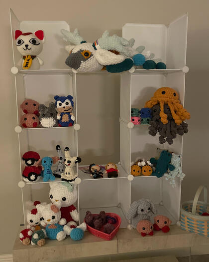 Seven Grid cubes with animal and video game inspired crochet plushies. The left side of the image has video game plushies including Kirby, Sonic, Pokemon, and anime characters from Sanrio and Studio Ghibli. The right side of the setup has animal plushies.